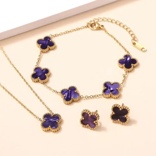 Violetiniai keturlapiai dobilai, papuošalų rinkinys su kaklo grandinėle, apyranke ir auskarais, elegantiškai išbaigtas komplektas.