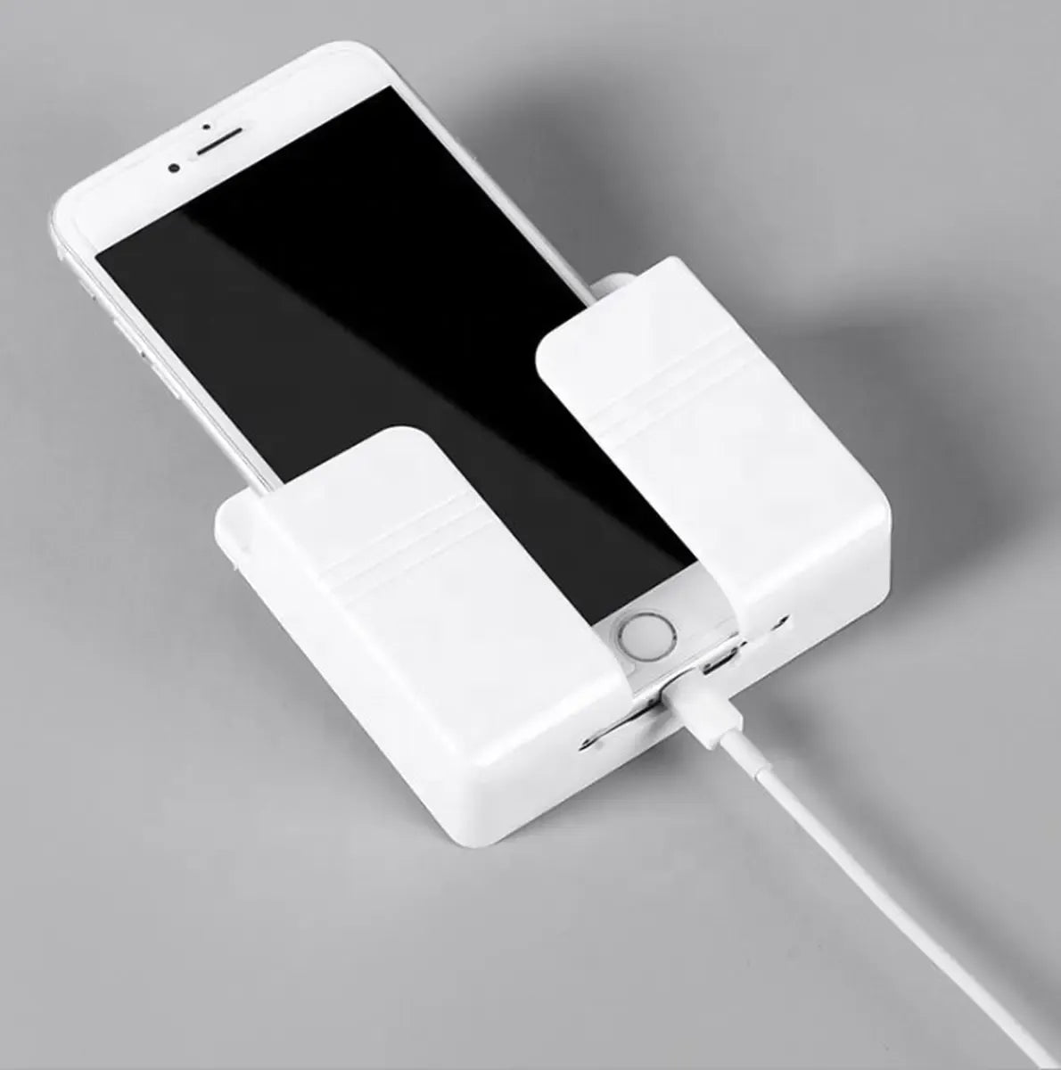 Universalus sieninis telefonų įkrovimo laikiklis, tvirtinamas prie sienos, patogus ir praktiškas telefonų įkrovimui.