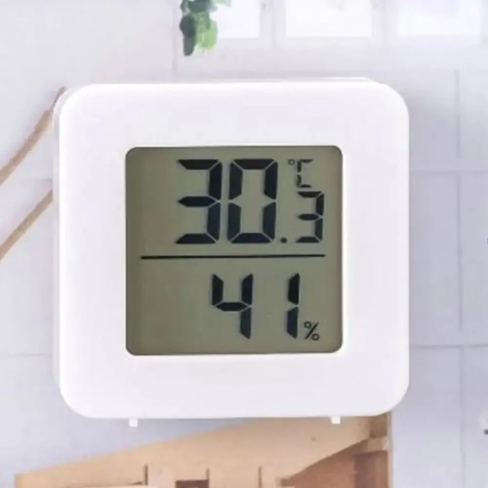Vidaus termometras-higrometras TR1668 rodyklėmis ir skaitmeniniu ekranu, matuoja kambario temperatūrą ir drėgmę.